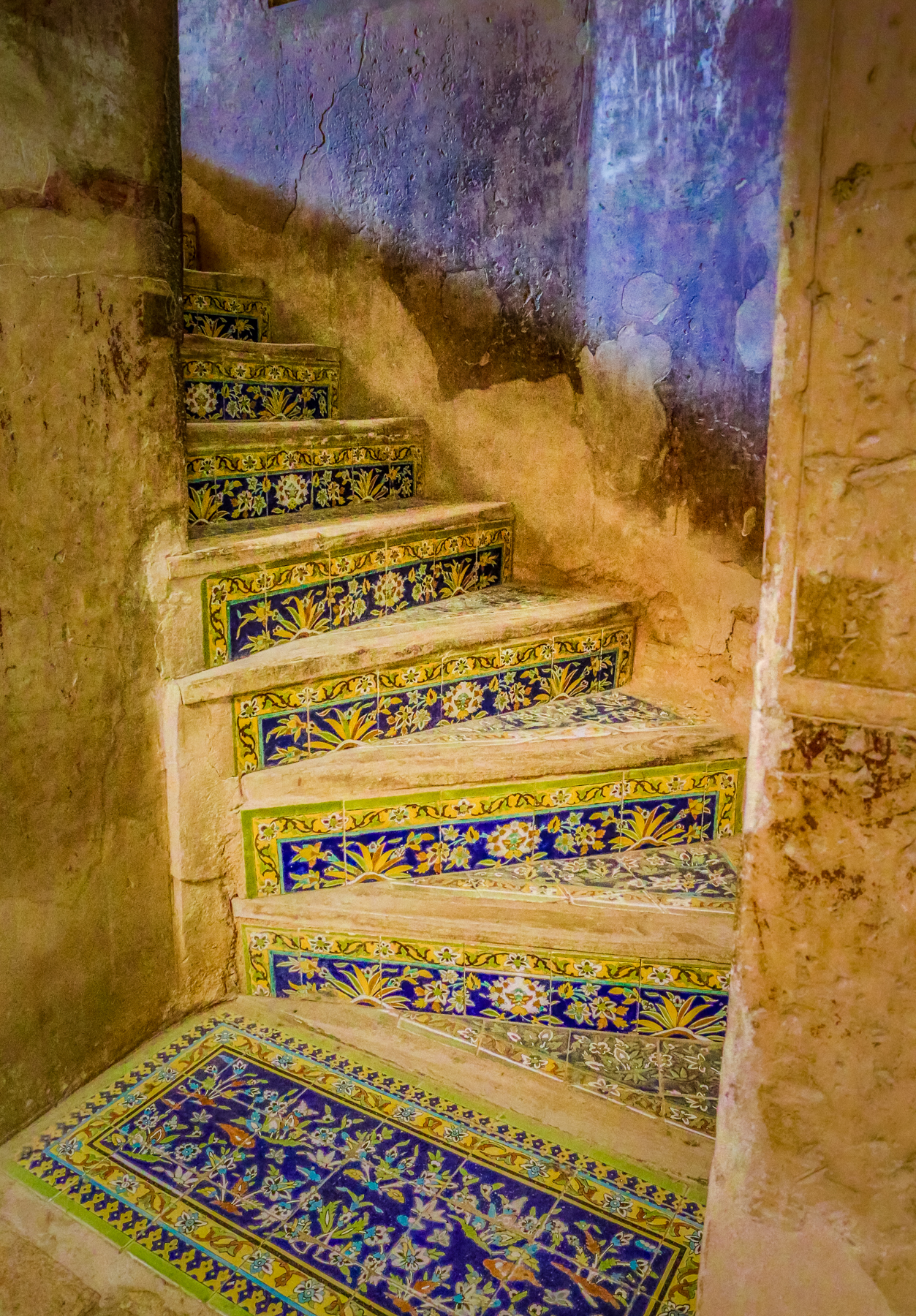 ornately crafted, brightly coloured, inlaid tile circular stairwell ascending upwards